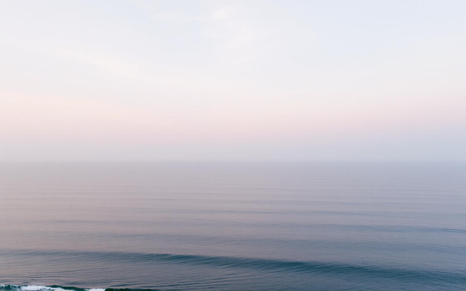 A calm tropical ocean horizon at dawn.